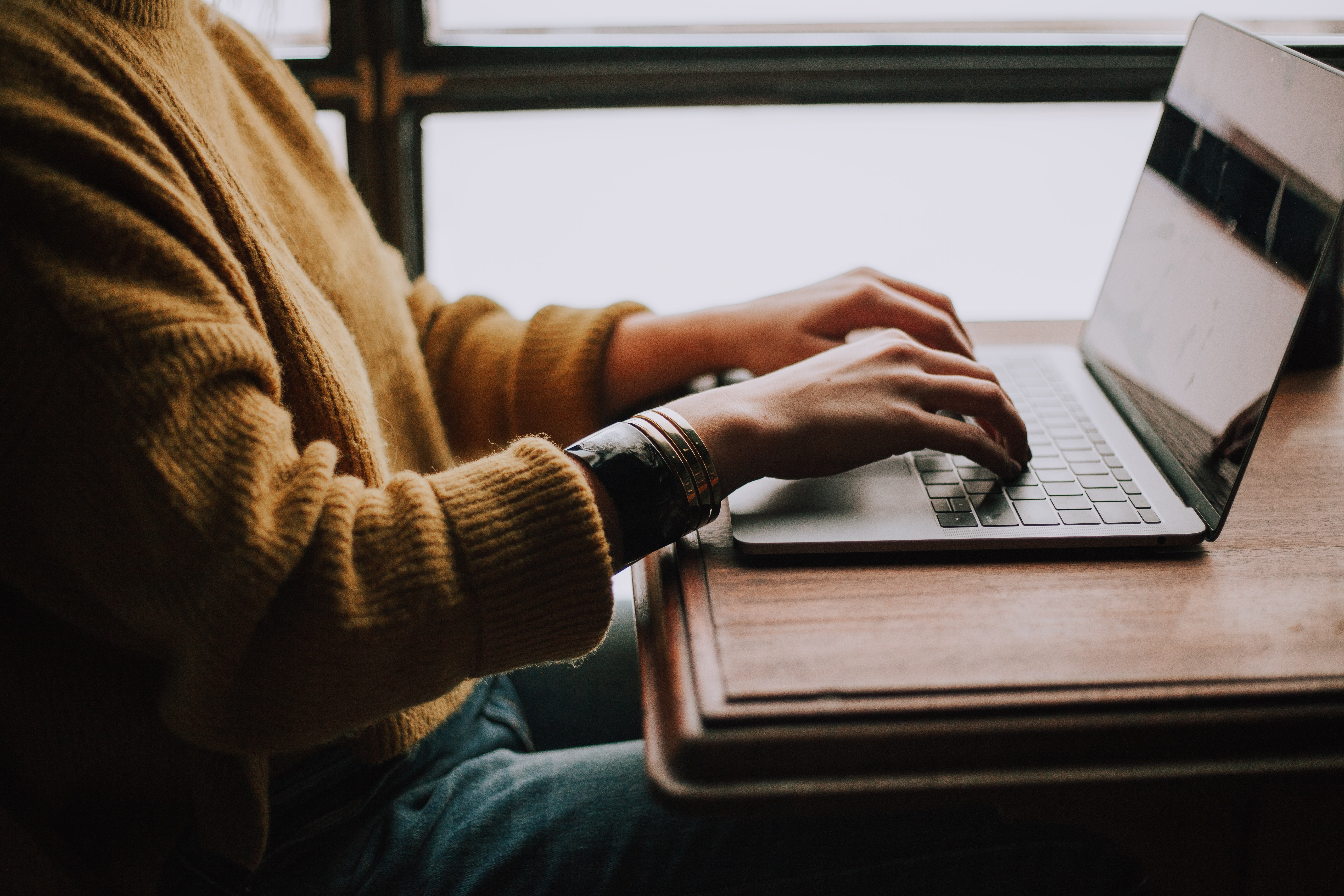A person alone in front of a laptop